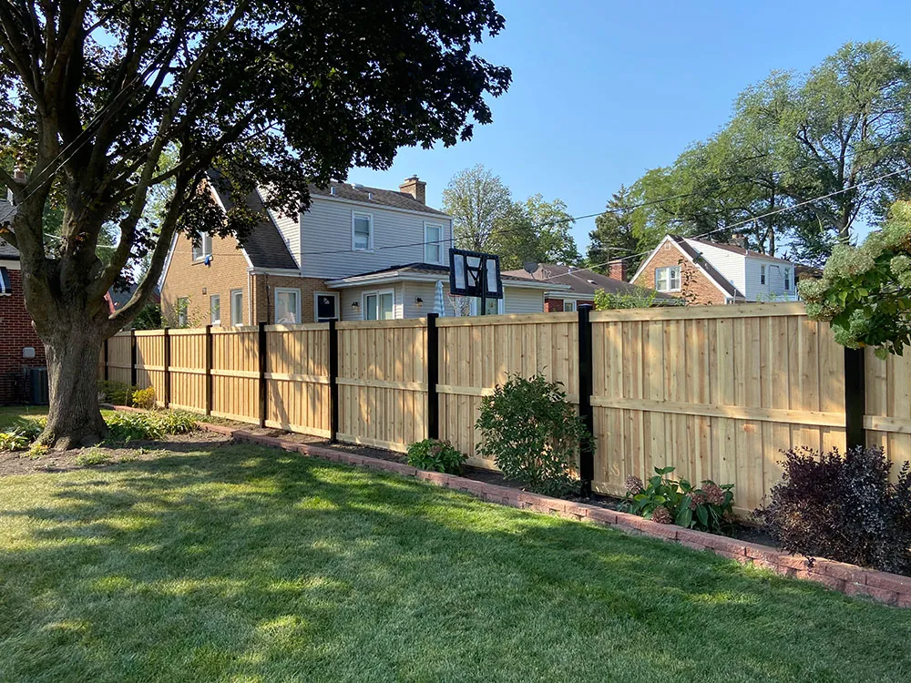 Wood privacy fence with black posts installed in Oak Lawn, Illinois